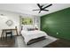 Serene bedroom featuring a queen-size bed, a green accent wall, and a cozy atmosphere with great natural light at 6845 E Osborn Rd # D, Scottsdale, AZ 85251