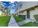 Charming townhouse exterior with well-maintained landscaping, walkway, and inviting front entrance at 6845 E Osborn Rd # D, Scottsdale, AZ 85251