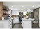 Bright, modern kitchen with white cabinets, stainless steel appliances, concrete countertops, and wood-look backsplash at 6845 E Osborn Rd # D, Scottsdale, AZ 85251