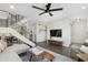Open concept living room showcasing a modern staircase, entertainment center, and comfortable seating area at 6845 E Osborn Rd # D, Scottsdale, AZ 85251