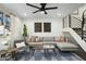 Inviting living room with a comfortable sectional sofa, stylish decor, ceiling fan, and modern staircase at 6845 E Osborn Rd # D, Scottsdale, AZ 85251