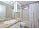Bathroom featuring a single sink vanity with granite countertops, and a shower with a patterned curtain at 7420 W Los Gatos Dr, Glendale, AZ 85310