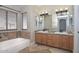 Bathroom with double vanity, tub, and tiled flooring at 7420 W Los Gatos Dr, Glendale, AZ 85310