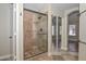 Bathroom featuring a glass enclosed shower and sliding mirror door closet at 7420 W Los Gatos Dr, Glendale, AZ 85310