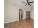 Bedroom with ceiling fan, wood floors, and en suite bathroom at 7420 W Los Gatos Dr, Glendale, AZ 85310