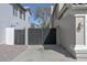 Wide driveway and fenced-in gate between houses for privacy and security at 7420 W Los Gatos Dr, Glendale, AZ 85310