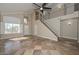 Spacious living room with tile floors, high ceilings, a staircase, and large windows at 7420 W Los Gatos Dr, Glendale, AZ 85310