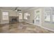 Cozy living room featuring a stone fireplace, multiple windows, and tile flooring at 7420 W Los Gatos Dr, Glendale, AZ 85310