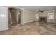 Comfortable living room featuring a stone fireplace, staircase, and tile flooring at 7420 W Los Gatos Dr, Glendale, AZ 85310