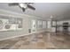 Open living room featuring backyard access, tile flooring, and kitchen view at 7420 W Los Gatos Dr, Glendale, AZ 85310