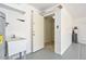 Mud room with a utility sink, water heater, and access door to the interior at 7420 W Los Gatos Dr, Glendale, AZ 85310