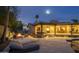 Beautiful backyard featuring a pool, lounge area, and mountain views, illuminated at twilight at 7508 N 21St St, Phoenix, AZ 85020