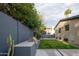 Backyard featuring a built-in grill, green lawn, cacti and modern patio design at 7508 N 21St St, Phoenix, AZ 85020