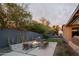 Backyard featuring a fire pit, grill, green lawn, cacti and modern patio design at 7508 N 21St St, Phoenix, AZ 85020