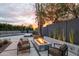 Relaxing backyard with a modern fire pit, comfortable lounge chairs, and lush landscaping at sunset at 7508 N 21St St, Phoenix, AZ 85020
