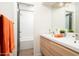 Bathroom features a white vanity with double sinks and an adjacent room with a shower over tub combination at 7508 N 21St St, Phoenix, AZ 85020