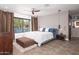 Spacious bedroom featuring a large window with natural light, ensuite bathroom, and modern ceiling fan at 7508 N 21St St, Phoenix, AZ 85020