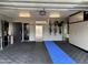 Well-organized garage with ample storage cabinets, a utility sink, and a blue-and-black tiled floor at 7508 N 21St St, Phoenix, AZ 85020