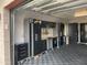 Showcasing a functional garage featuring storage cabinets, work bench, and a gray tiled floor at 7508 N 21St St, Phoenix, AZ 85020