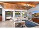 Bright living room features modern decor, wood ceilings, and seamless indoor-outdoor living with a view of the pool at 7508 N 21St St, Phoenix, AZ 85020
