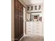 Custom walk-in closet featuring built-in shelving, drawers, and decorative accents for optimal storage and style at 7508 N 21St St, Phoenix, AZ 85020