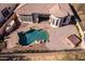 Aerial view of a backyard showcasing a sparkling pool, patio area, and a cozy spa, ideal for relaxation at 8041 E Teton Cir, Mesa, AZ 85207