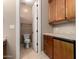 Bathroom with a granite counter, wood cabinets, and an open toilet room at 8041 E Teton Cir, Mesa, AZ 85207