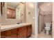 Bathroom featuring a vanity with storage, a mirror, and a toilet with a shower at 8041 E Teton Cir, Mesa, AZ 85207