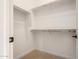 Walk-in closet with carpet floors and shelving at 8041 E Teton Cir, Mesa, AZ 85207