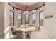 Charming dining area features a round table, comfortable chairs, and lots of natural light through the many windows at 8041 E Teton Cir, Mesa, AZ 85207