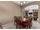 Elegant dining room with wood table and chairs, chandelier, and an open layout leading to the inviting living space at 8041 E Teton Cir, Mesa, AZ 85207