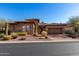 Inviting desert home featuring stone accents, tile roof, and a charming xeriscaped front yard at 8041 E Teton Cir, Mesa, AZ 85207