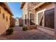 Lovely courtyard with brick pavers, rock facade and iron gate at 8041 E Teton Cir, Mesa, AZ 85207