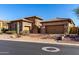 Elegant stone and stucco home with well-maintained desert landscaping and spacious driveway at 8041 E Teton Cir, Mesa, AZ 85207