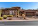 Beautiful stone home featuring a tile roof, two car garage, and desert landscaping at 8041 E Teton Cir, Mesa, AZ 85207