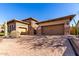 Elegant stone and stucco home with well-maintained desert landscaping and spacious driveway at 8041 E Teton Cir, Mesa, AZ 85207