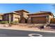 Elegant stone and stucco home with well-maintained desert landscaping and spacious driveway at 8041 E Teton Cir, Mesa, AZ 85207
