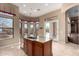 Bright kitchen with an island and breakfast bar, flowing seamlessly into an outdoor dining area with scenic views at 8041 E Teton Cir, Mesa, AZ 85207