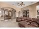 Spacious living room with an open layout, featuring arched doorways and comfortable leather seating, perfect for relaxation at 8041 E Teton Cir, Mesa, AZ 85207