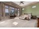 Bright main bedroom with expansive windows, a ceiling fan, and ample space for relaxation and rest at 8041 E Teton Cir, Mesa, AZ 85207