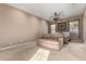 Spacious main bedroom with carpet floors, a ceiling fan, and a comfortable couch at 8041 E Teton Cir, Mesa, AZ 85207