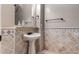 Elegant powder room features decorative tile accents, a pedestal sink, and updated fixtures at 8041 E Teton Cir, Mesa, AZ 85207