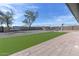 Big open backyard features low-maintenance turf and hardscape; ample room for Gathering and entertaining at 8451 W Plum Hollow Dr, Arizona City, AZ 85123