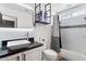 Modern bathroom with a sleek vanity, black countertops, white subway tile, and decorative shelving at 8451 W Plum Hollow Dr, Arizona City, AZ 85123