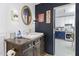 Bathroom with stylish vanity, white sink, and a view into the updated kitchen at 8451 W Plum Hollow Dr, Arizona City, AZ 85123