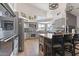 Well-equipped kitchen with stainless steel appliances, gray cabinets, and a large center island at 8451 W Plum Hollow Dr, Arizona City, AZ 85123