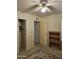 Carpeted bedroom with a ceiling fan, closet, and built in wooden shelving at 8815 W Avenida De Amigos Cir # 118, Arizona City, AZ 85123