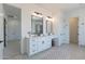 Spacious bathroom with dual vanities, modern fixtures, and access to the bedroom and walk-in shower at 9318 E Cloudview Ave, Gold Canyon, AZ 85118