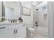Bright bathroom featuring a white vanity with black hardware and a shower-tub combination at 9318 E Cloudview Ave, Gold Canyon, AZ 85118
