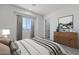 A neutral bedroom boasts natural light, complemented by wood furniture and tasteful decor at 9318 E Cloudview Ave, Gold Canyon, AZ 85118